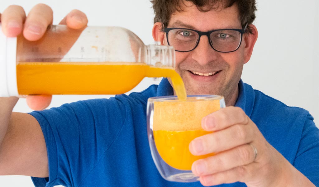 pouring carbonated orange juice